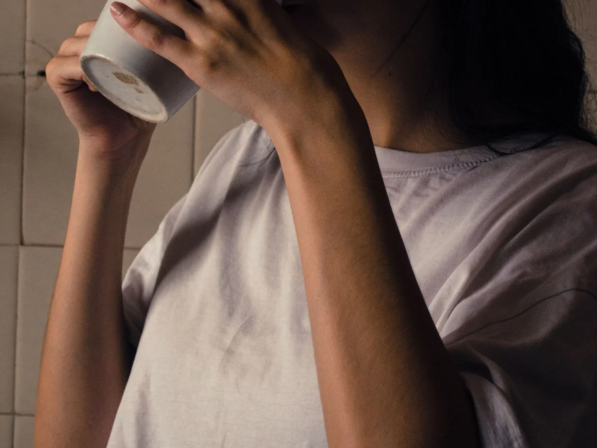 Woman making coffee at a compact home kitchen counter