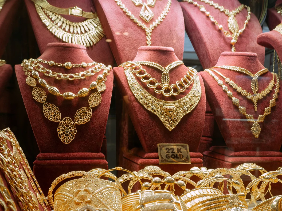 Woman cleaning and storing everyday jewelry at a dresser