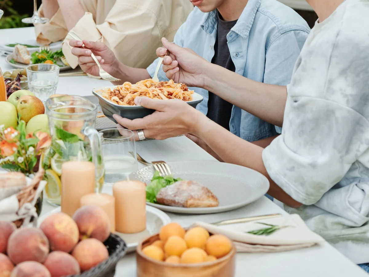 Multigenerational family gathering around a thoughtfully set holiday table
